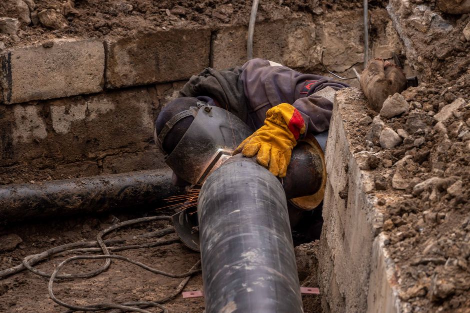 Close-up of a drainpipe being repaired outdoors in a Wiltshire garden
